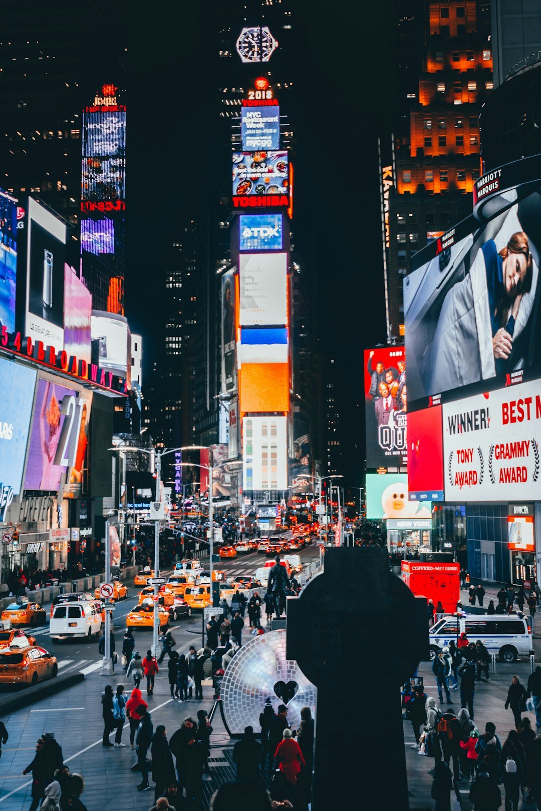 people-walking-on-street-surrounded-by-high-buildings-during-nighttime-athrxc5gi2s